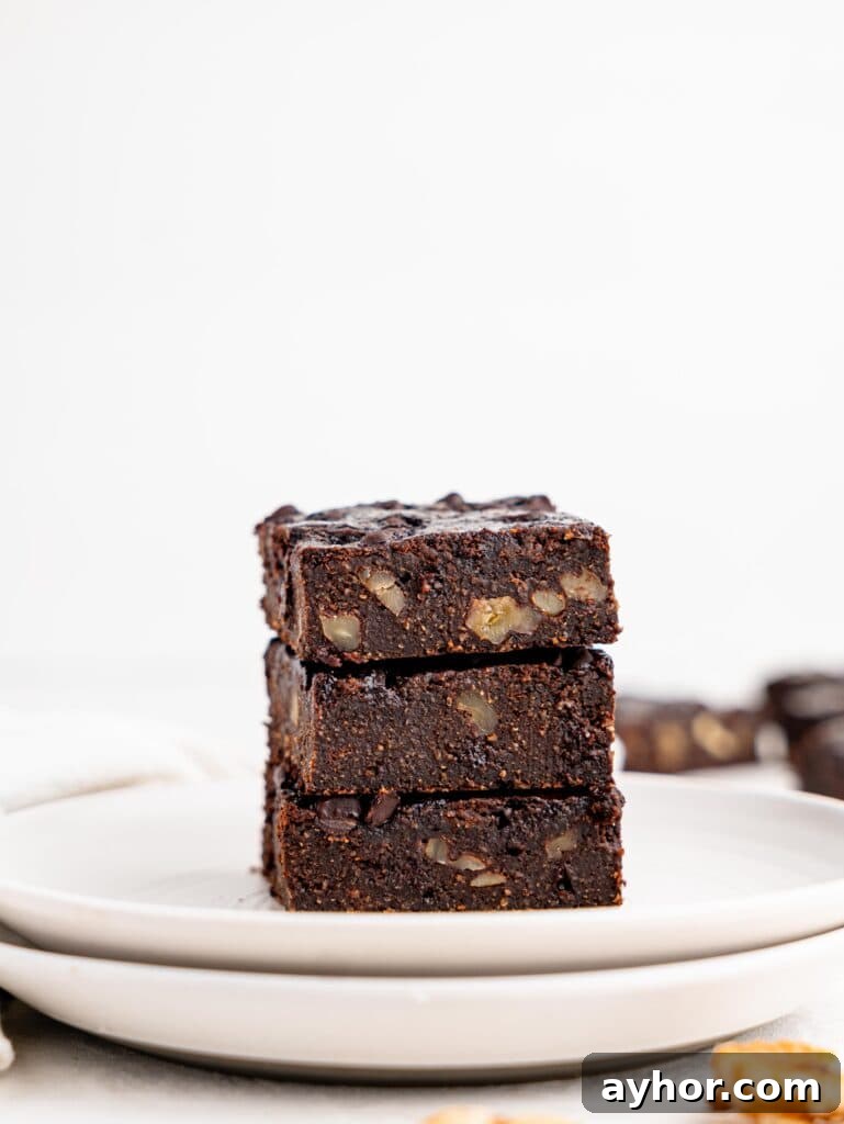 Three cottage cheese brownies on a white plate.