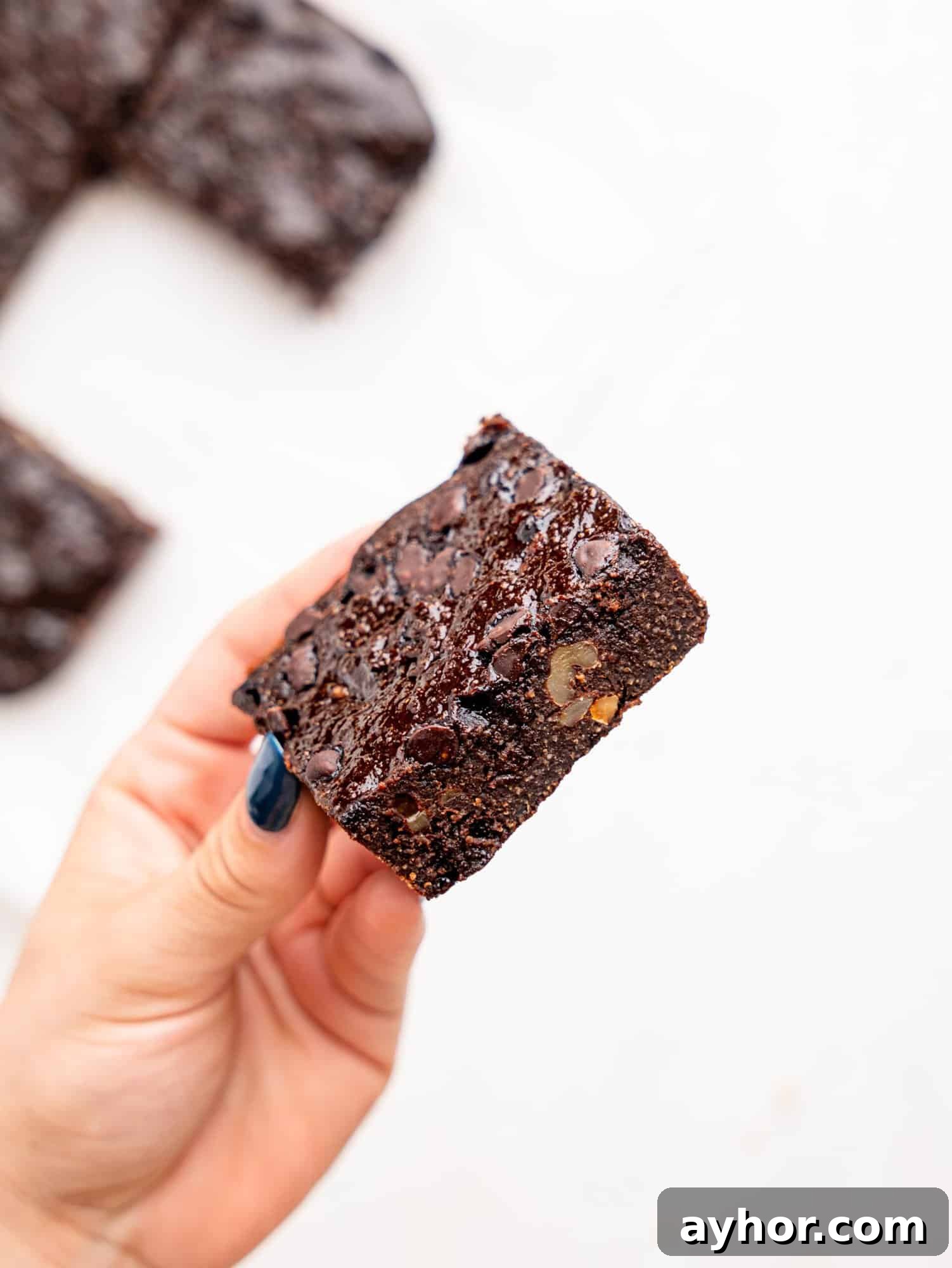 a hand holding a cottage cheese brownie.