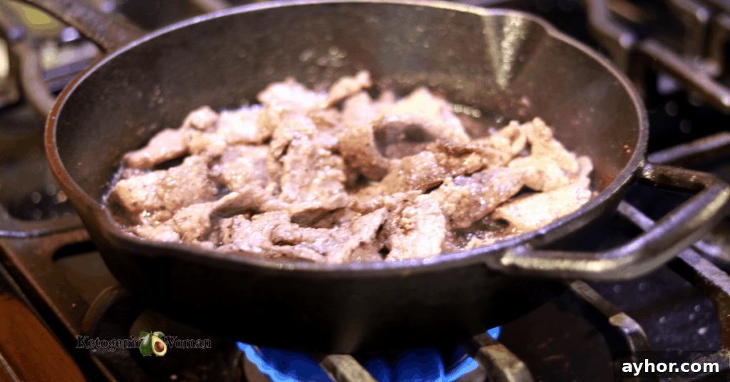 Keto Philly Cheesesteak Skillet: Low-Carb Dinner Recipe 4 steak frying in cast iron pan over a flame