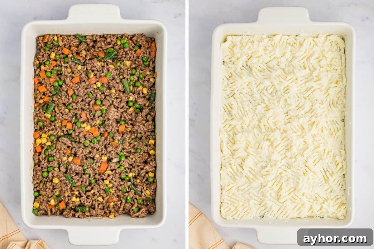 A white casserole dish with cooked ground beef and vegetables on the left and mashed potatoes spread on top on the right.