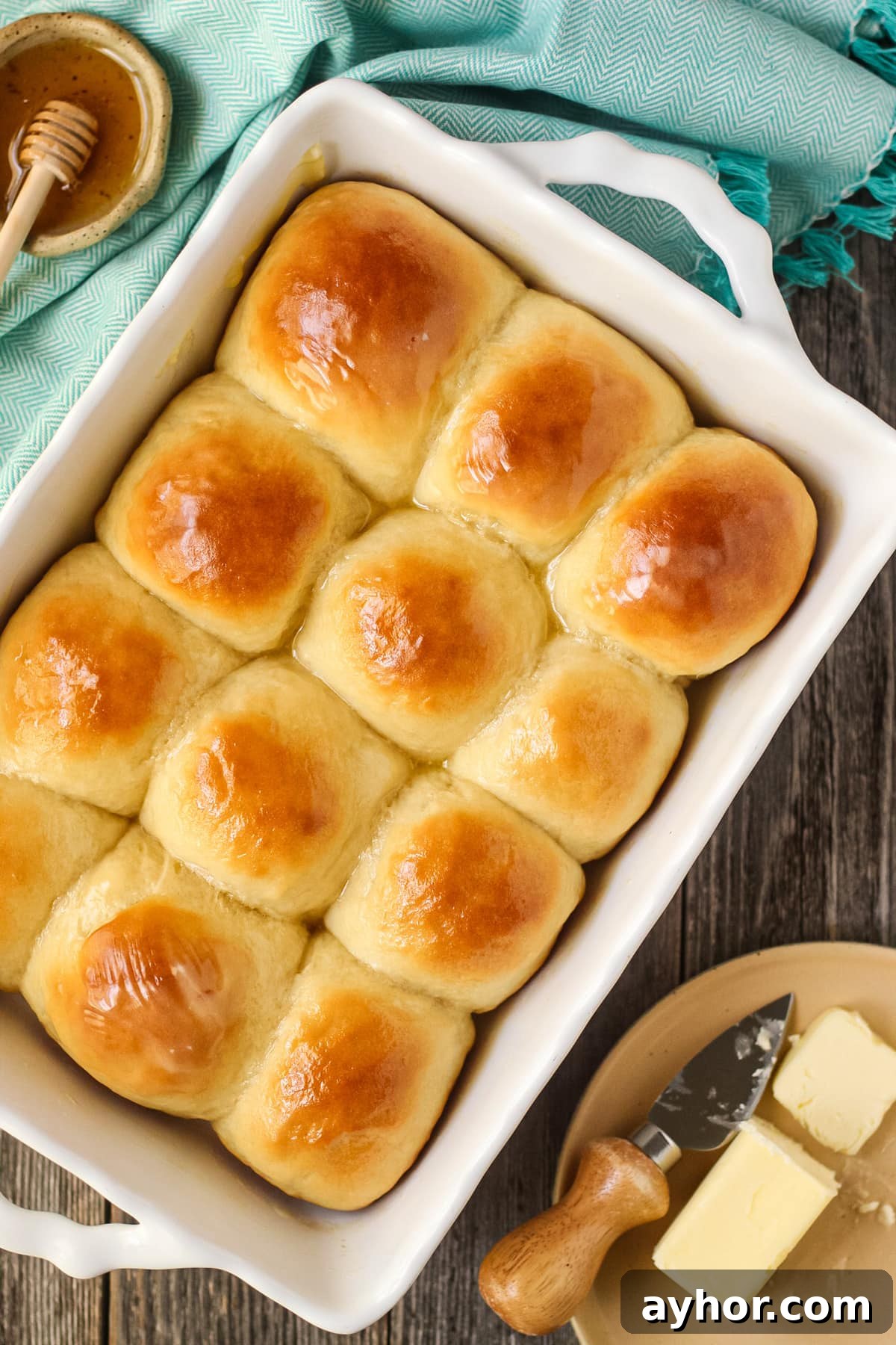 1-Hour Soft and Fluffy Dinner Rolls Recipe 11 honey butter yeast rolls in a white baking dish