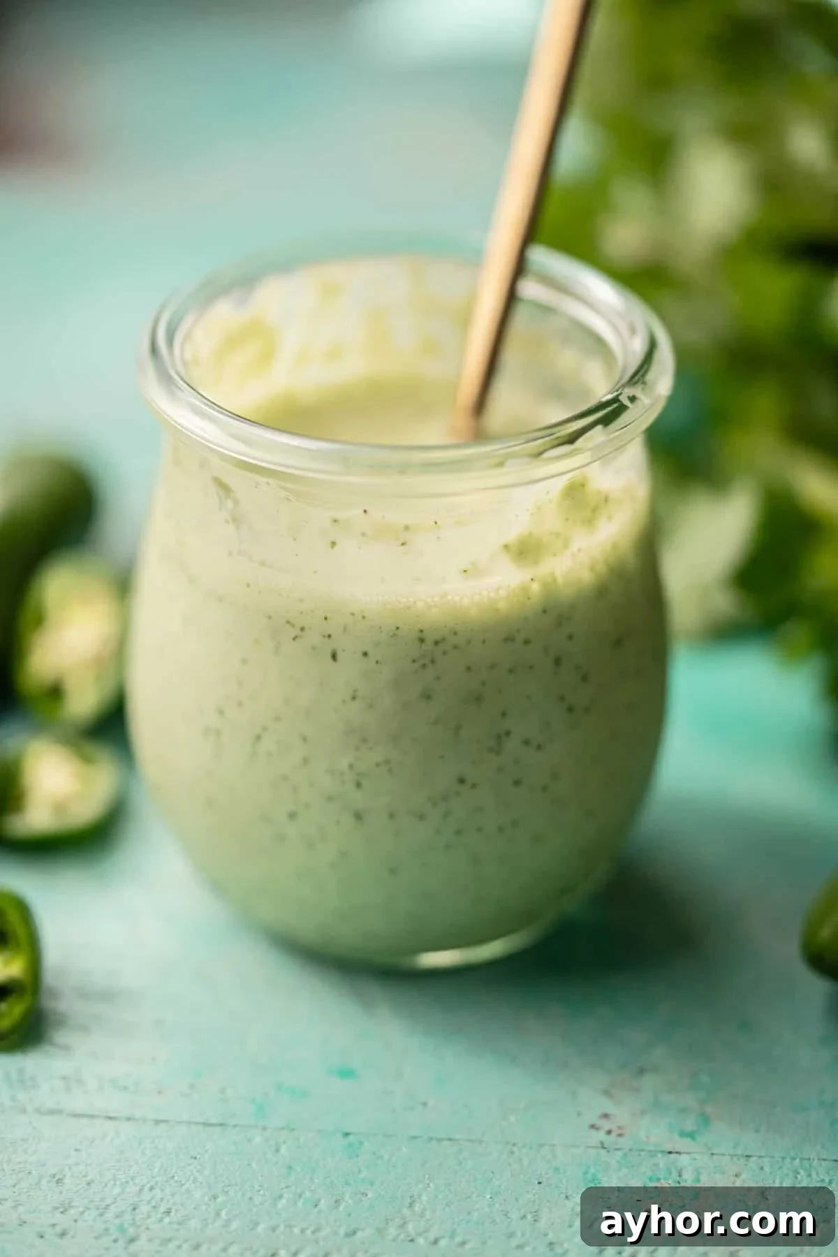 Creamy Jalapeño Ranch Dressing Recipe for Spicy Salads 5 homemade salad dressing surrounded with jalapenos and cilantro