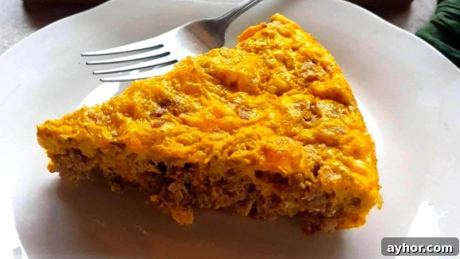A person cutting a piece out of a casserole.