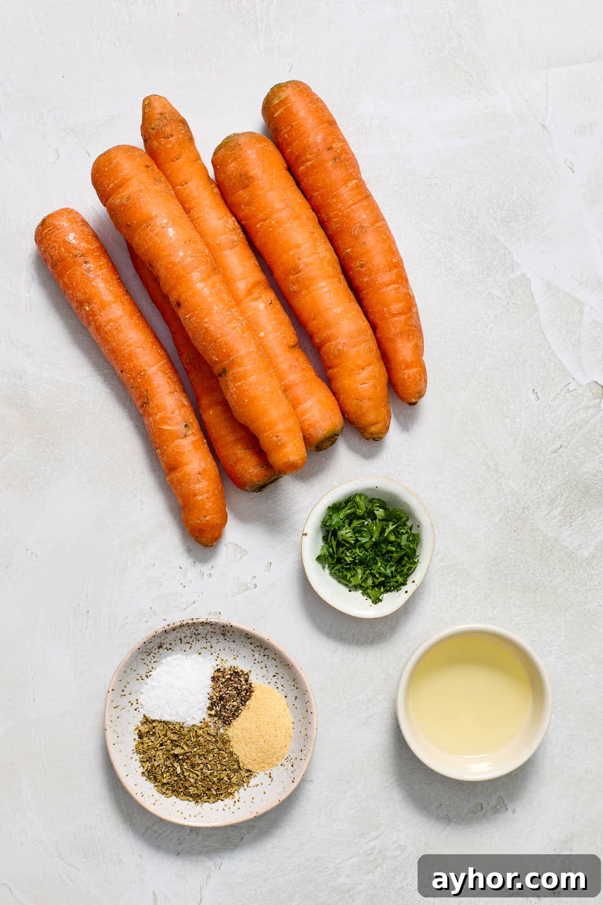 Ingredients to make air fryer carrots arranged individually.
