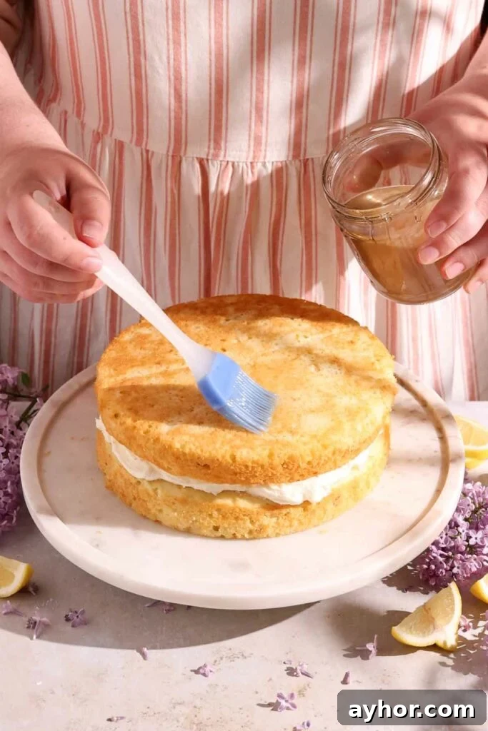 Lemon-Lilac Cake Recipe: Light Floral Citrus Dessert 10 brushing cake layers with lilac syrup