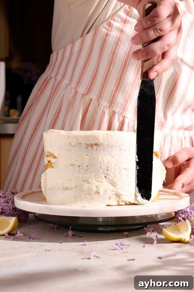 Lemon-Lilac Cake Recipe: Light Floral Citrus Dessert 11 covering cake with frosting