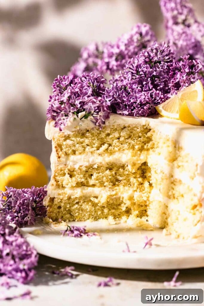 Lemon-Lilac Cake Recipe: Light Floral Citrus Dessert 3 Sliced lemon cake with lilacs on marble cake stand