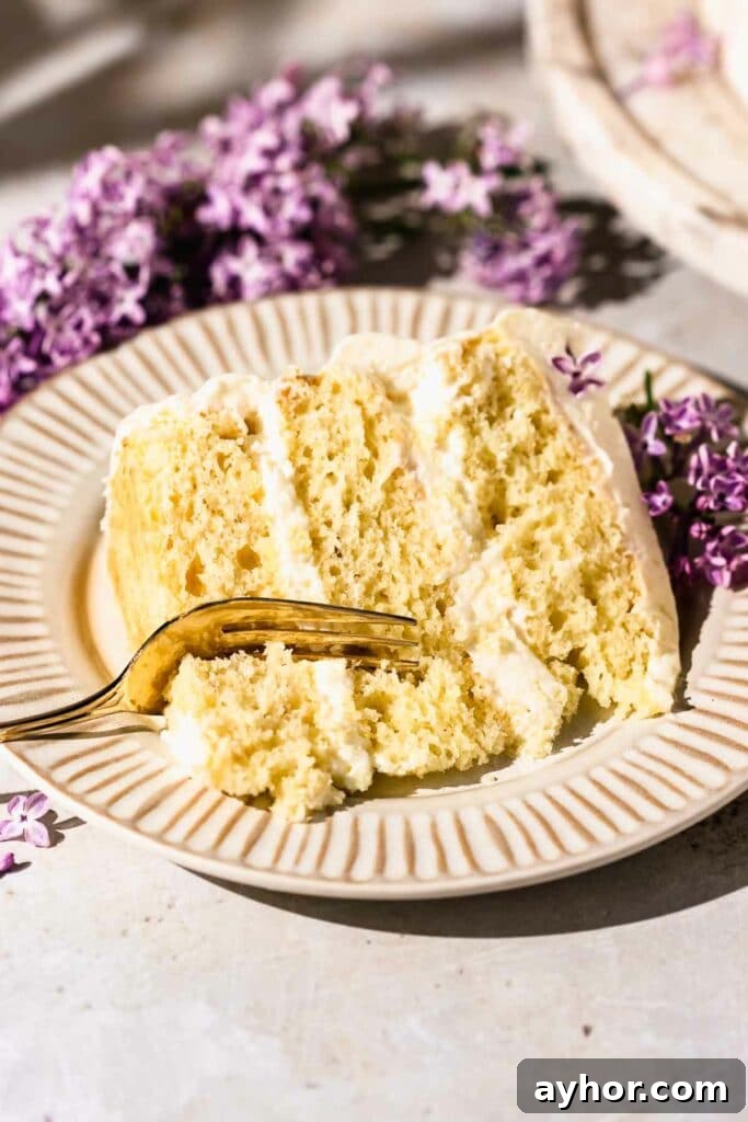 Lemon-Lilac Cake Recipe: Light Floral Citrus Dessert 5 Slice of cake with fork and fluted plate