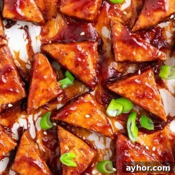 Grilled BBQ Tofu Recipe: Smoky, Glazed Plant-Based Dish 14 Crispy baked BBQ tofu triangles topped with sesame seeds and sliced green onions