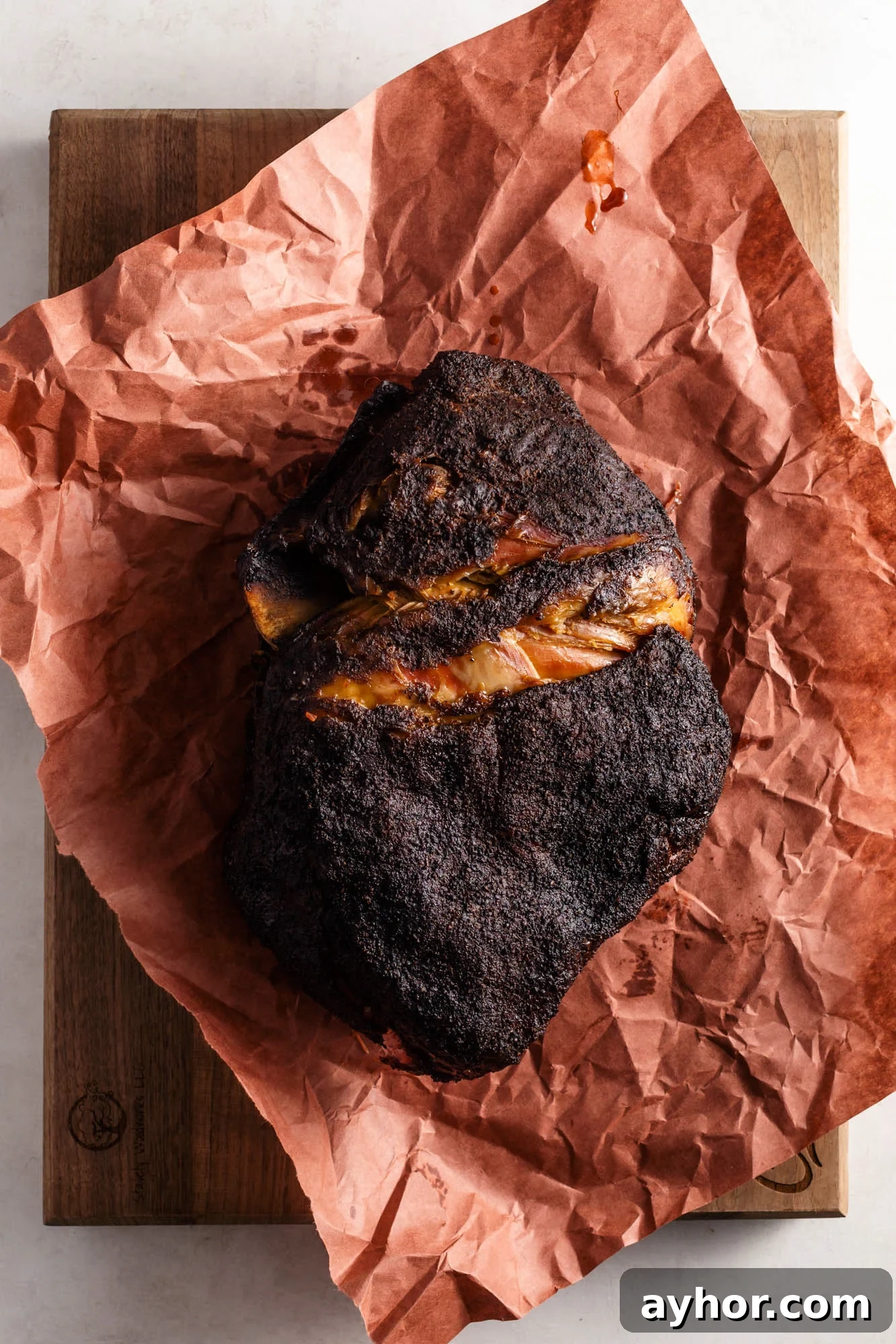 Smoking Pork Shoulder at 225°F: Time Guide for Tender Results 5 A whole bone-in smoked pork shoulder on butcher paper.