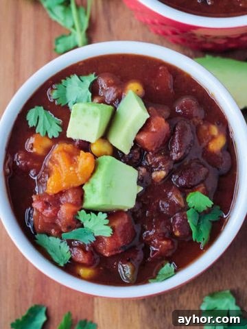 Bowl of crock pot vegan chili with black beans and butternut squash.
