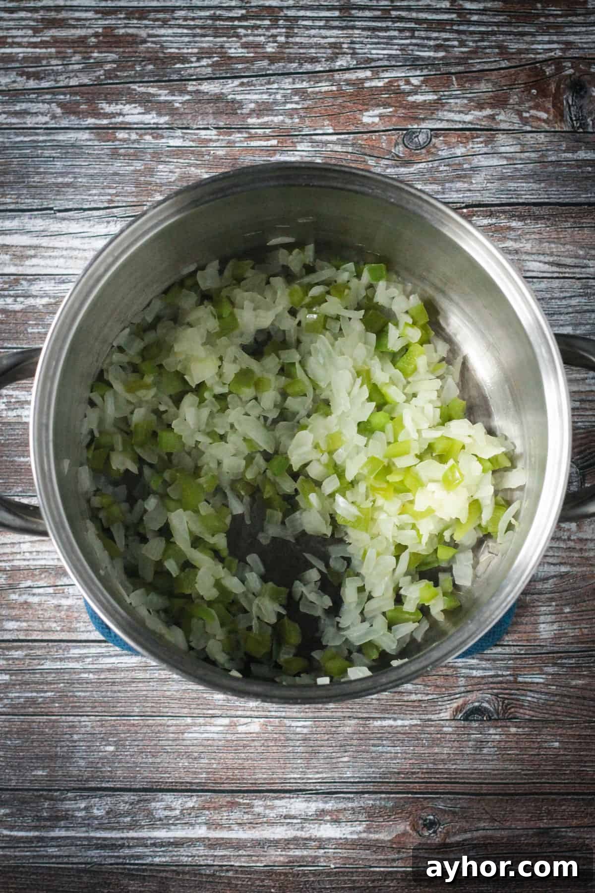 Sautéed onions and peppers in a soup pot.