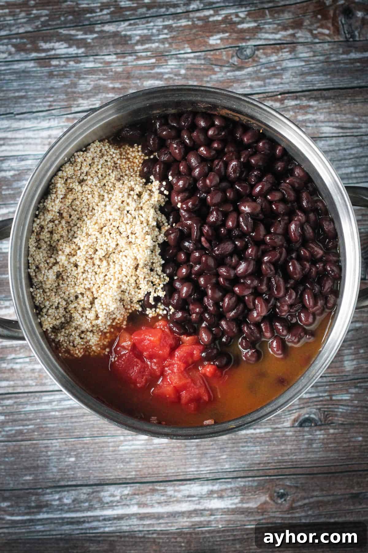 Beans, quinoa, and diced tomatoes added to the pot.