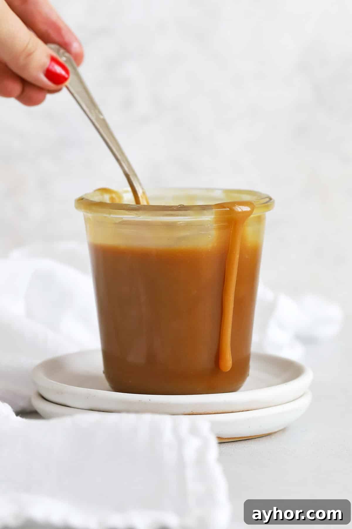 Homemade Caramel Sauce Recipe — Rich, Smooth & Pourable 8 front view of a jar of easy caramel sauce