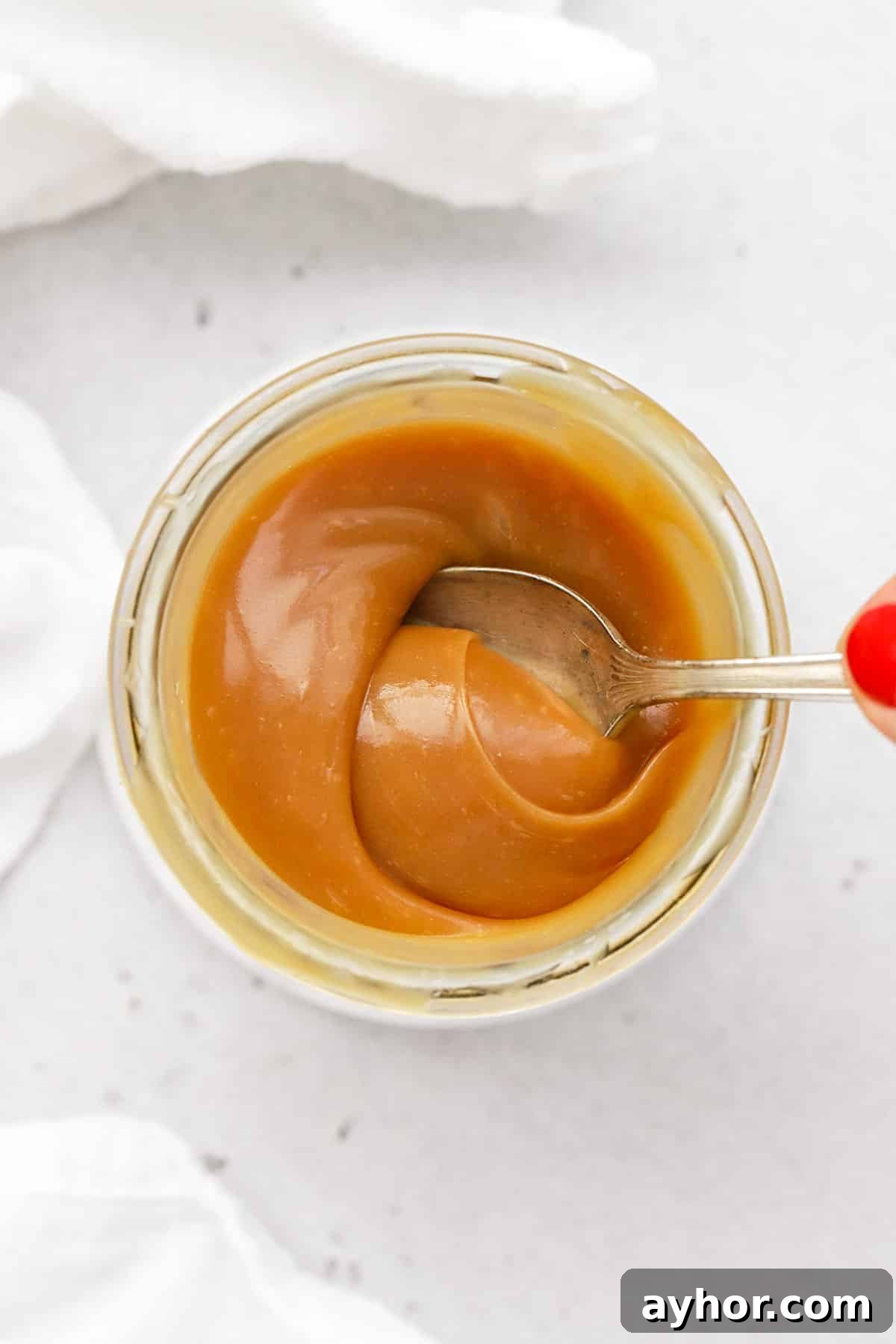 Homemade Caramel Sauce Recipe — Rich, Smooth & Pourable 9 Using a spoon to stir easy homemade caramel sauce