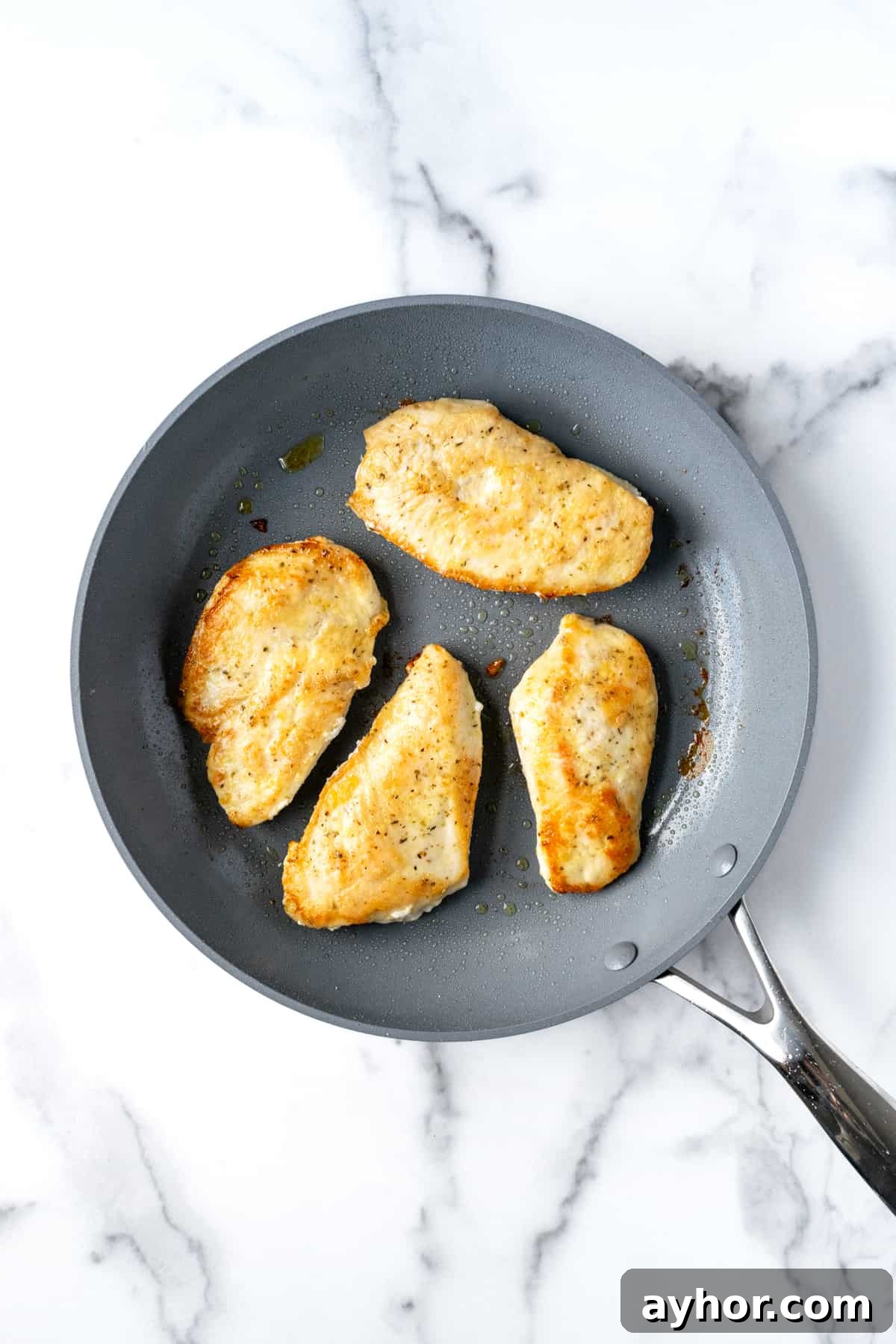 Creamy Chicken Florentine with Spinach and Garlic Sauce 4 Cooked Chicken Cutlets in a Skillet.