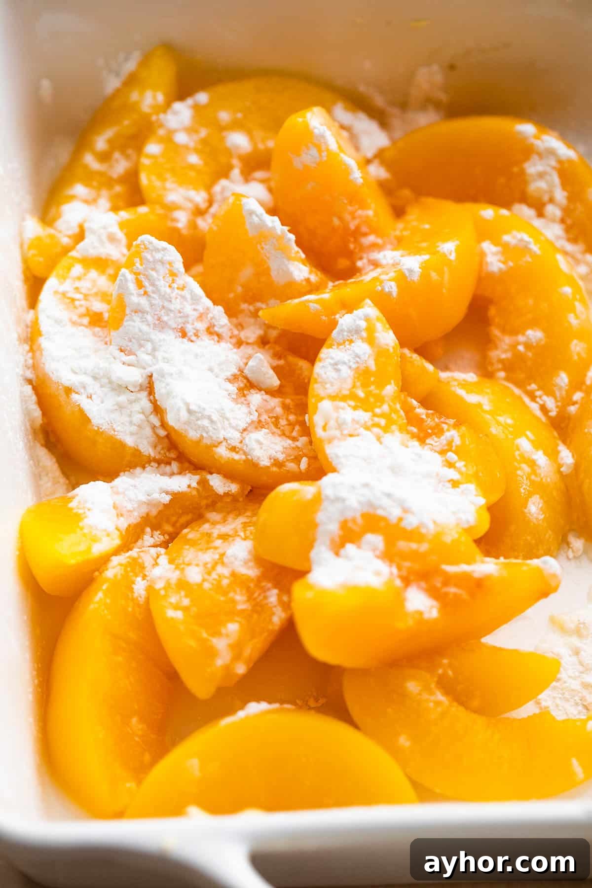 Perfect Peach Crisp Recipe for Summer Baking 4 sliced peaches tossed with cornstarch