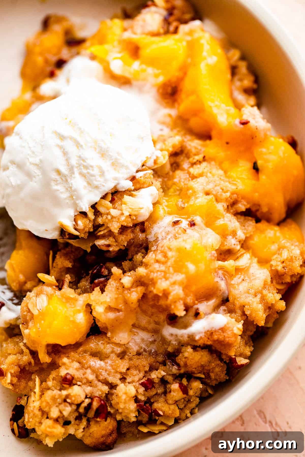 Perfect Peach Crisp Recipe for Summer Baking 7 bowl of peach crisp topped with a scoop of vanilla ice cream