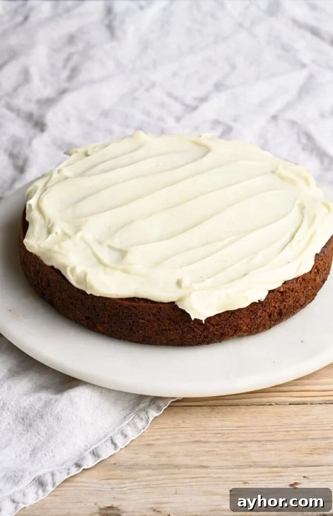 Moist Carrot Cake with Cream Cheese Frosting Recipe 10 Single layer of carrot cake topped with cream cheese frosting on a plate.
