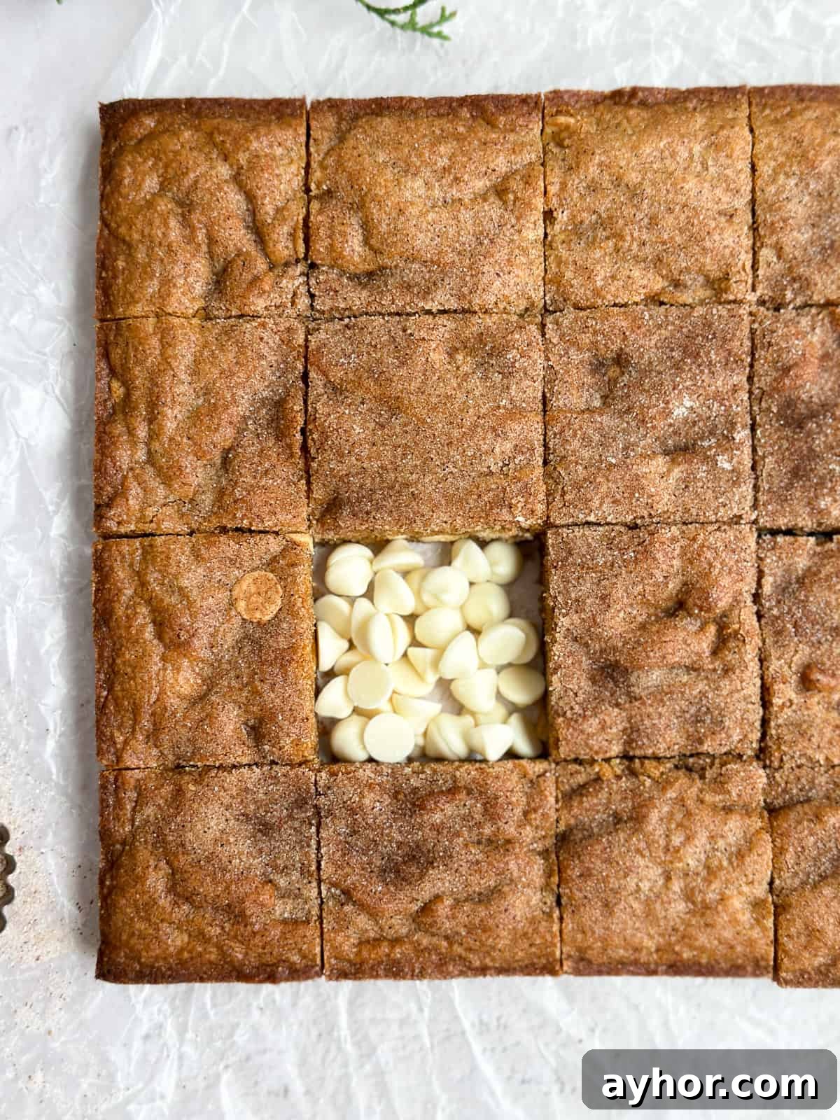 a close up of the gingerbread blondies with one square missing and the spot filled with white chocolate chips.