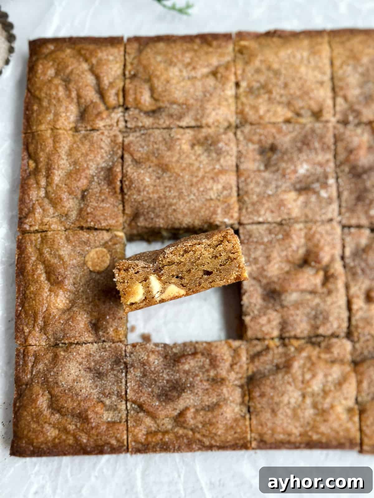 showing a gingerbread blondie turned up so you can see the white chocolate inside.