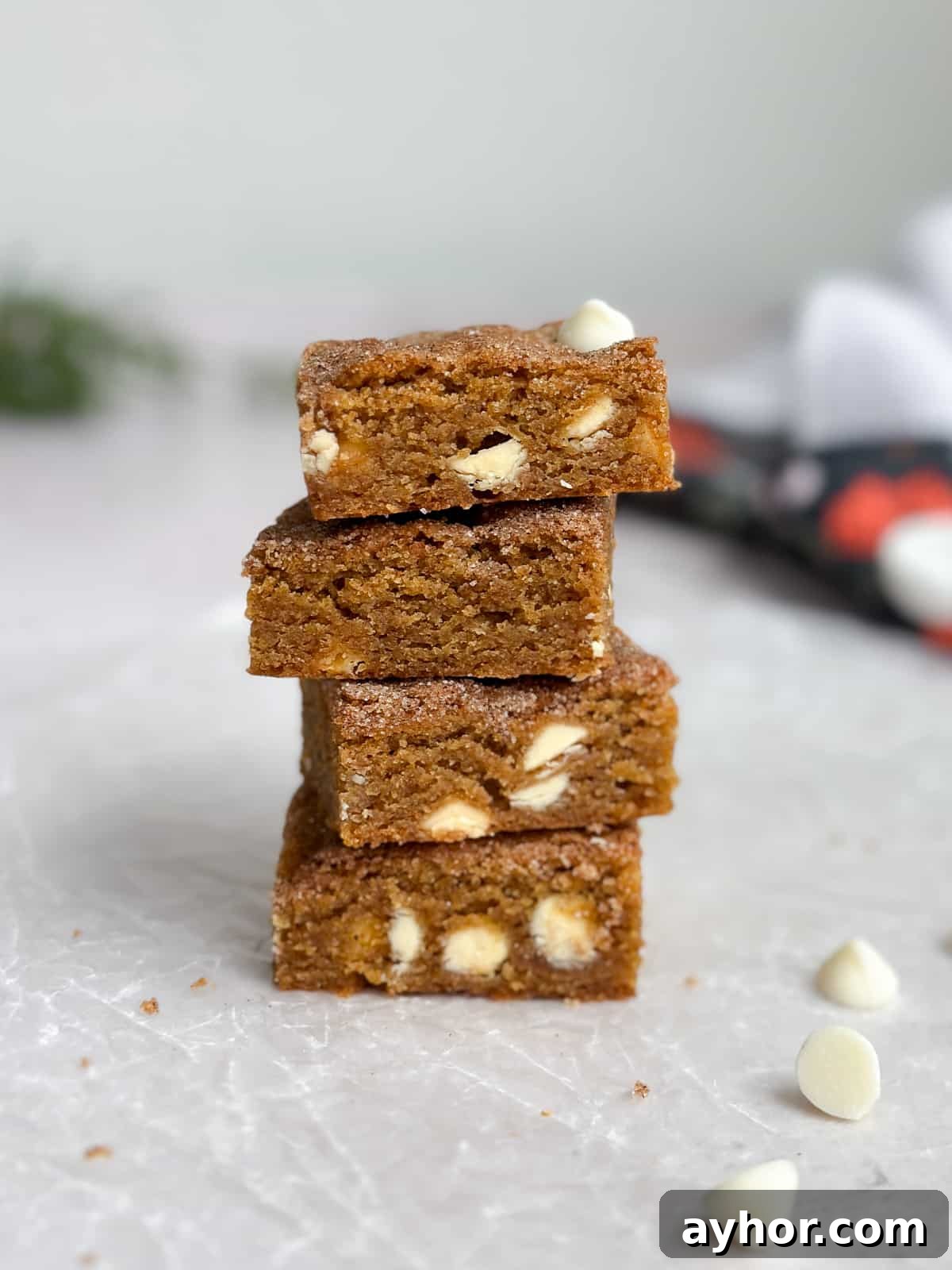 4 gingerbread blondies stacked on top of each other to see the inside texture.