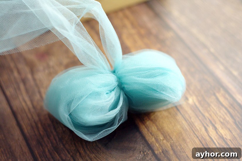 Cutting tulle loops to create bow tails