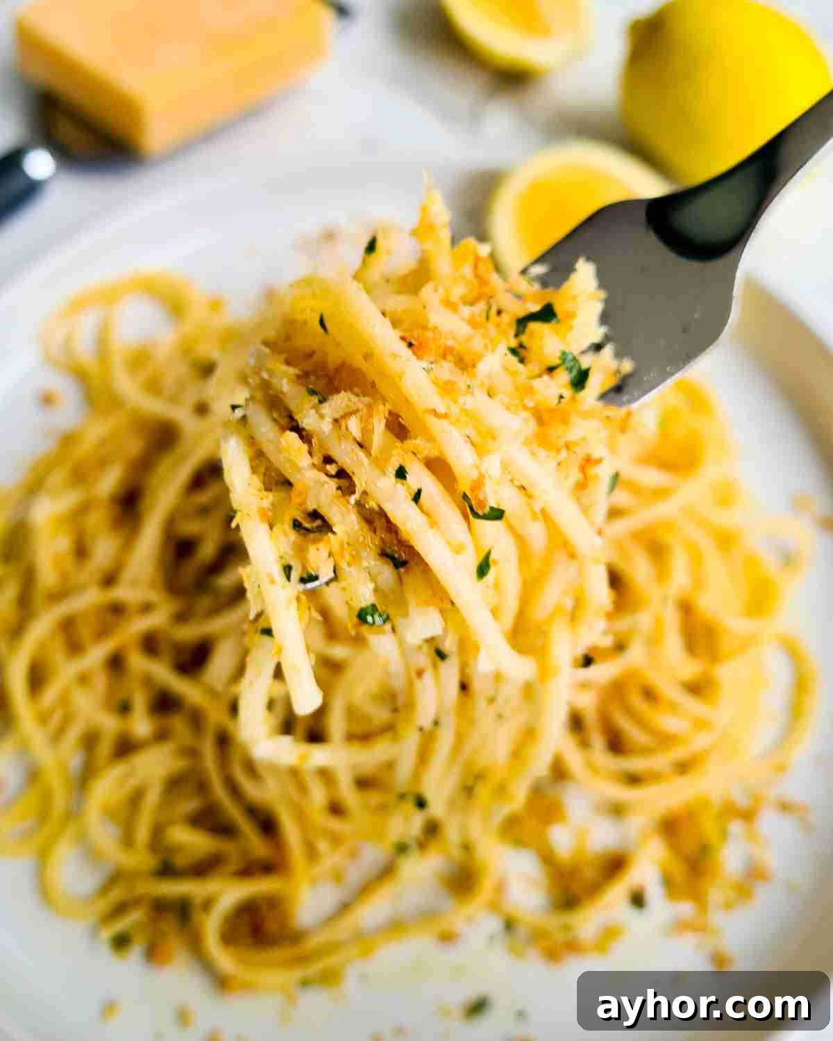 Creamy Lemon Garlic Butter Pasta Recipe for Quick Weeknight Meals 17 A forkful of lemon spaghetti over a plate