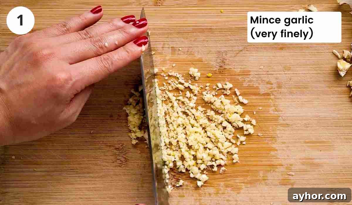 Creamy Lemon Garlic Butter Pasta Recipe for Quick Weeknight Meals 4 Garlic being minced with caption