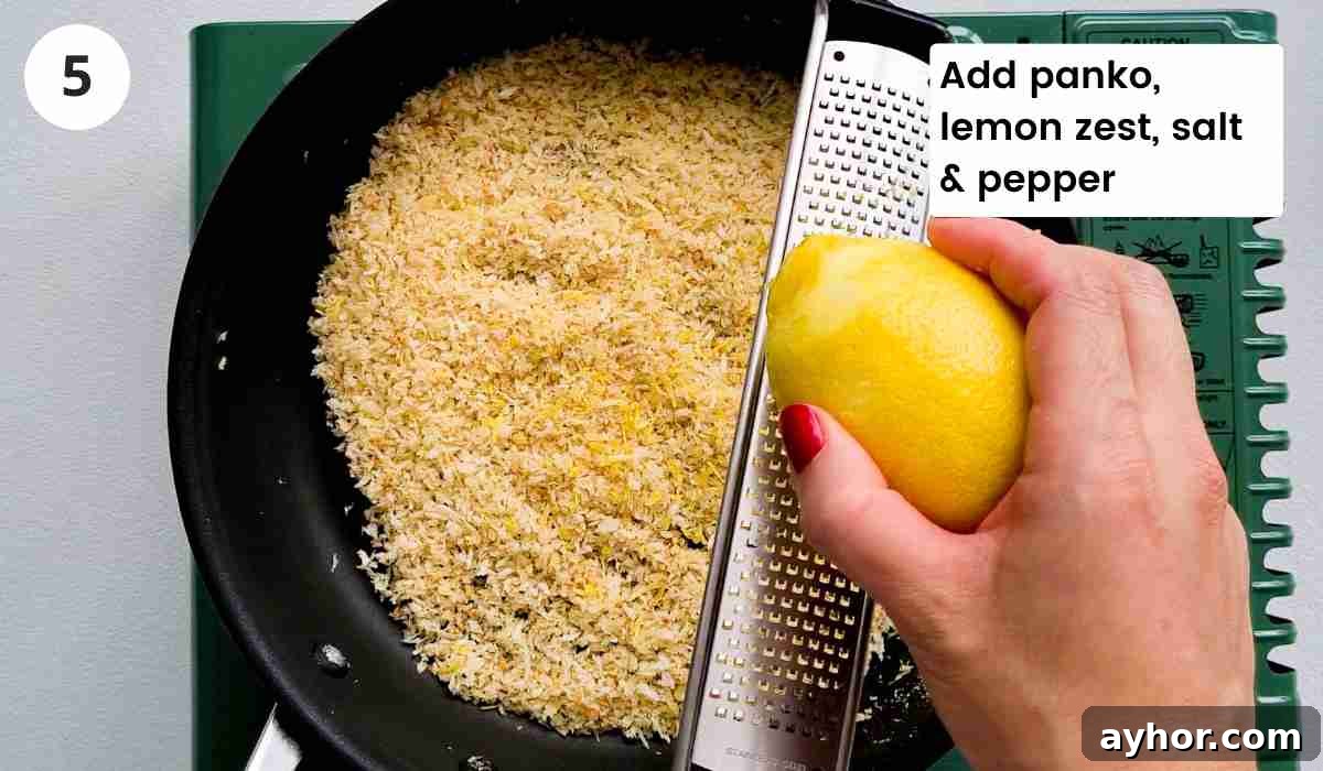 Creamy Lemon Garlic Butter Pasta Recipe for Quick Weeknight Meals 8 Breadcrumbs in frying pan with lemon being zested into the pan