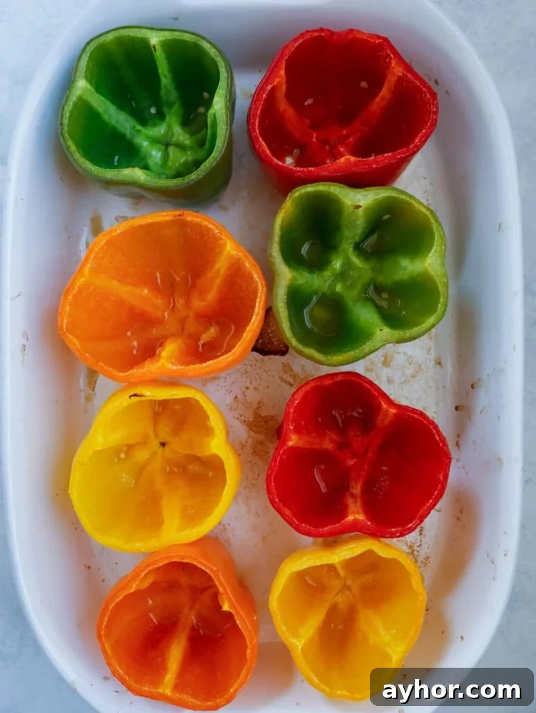Stuffed Bell Peppers with Quinoa and Ground Turkey 3 hollowed peppers in a baking dish.
