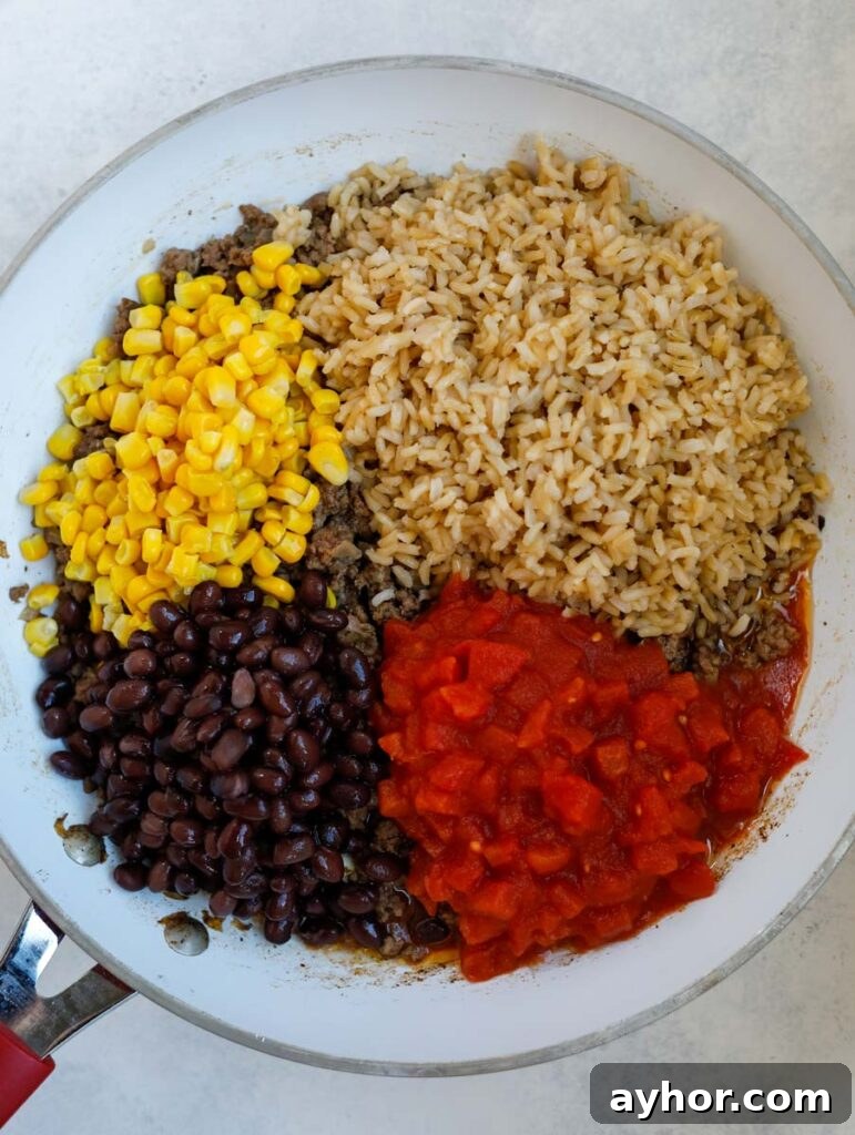 Stuffed Bell Peppers with Quinoa and Ground Turkey 4 beans, tomatoes, rice and corn in a skillet.