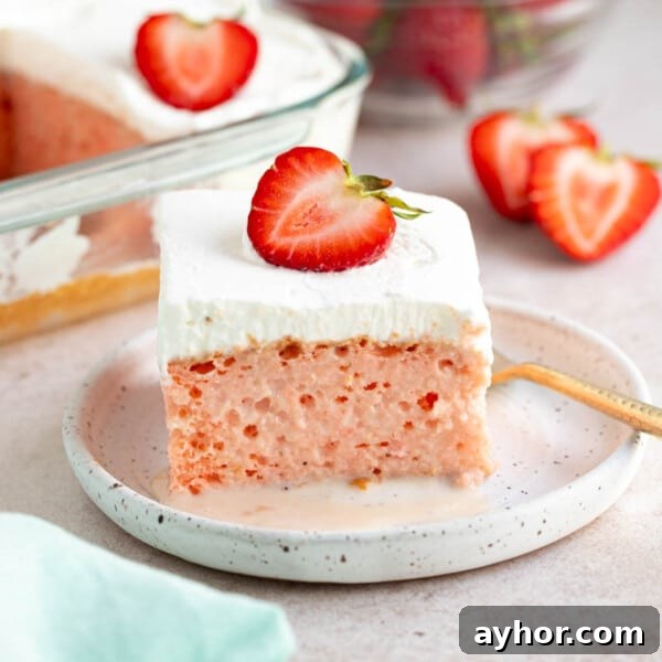 Ultimate S'mores Cookie Recipe: Crispy Edges & Gooey Centers 11 A slice of strawberry tres leches cake on a white plate for serving. Sliced strawberries and a bowl of strawberries sits to the site on a countertop.