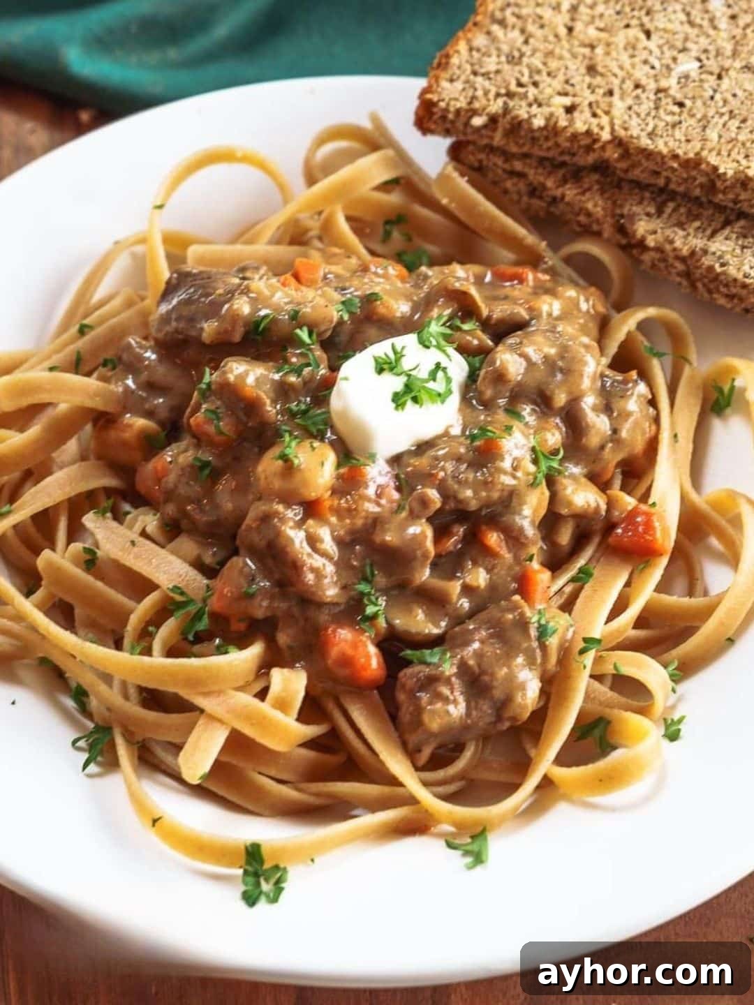 Top down view of a stroganoff recipe with carrots served over whole grain pasta - Hostess At Heart