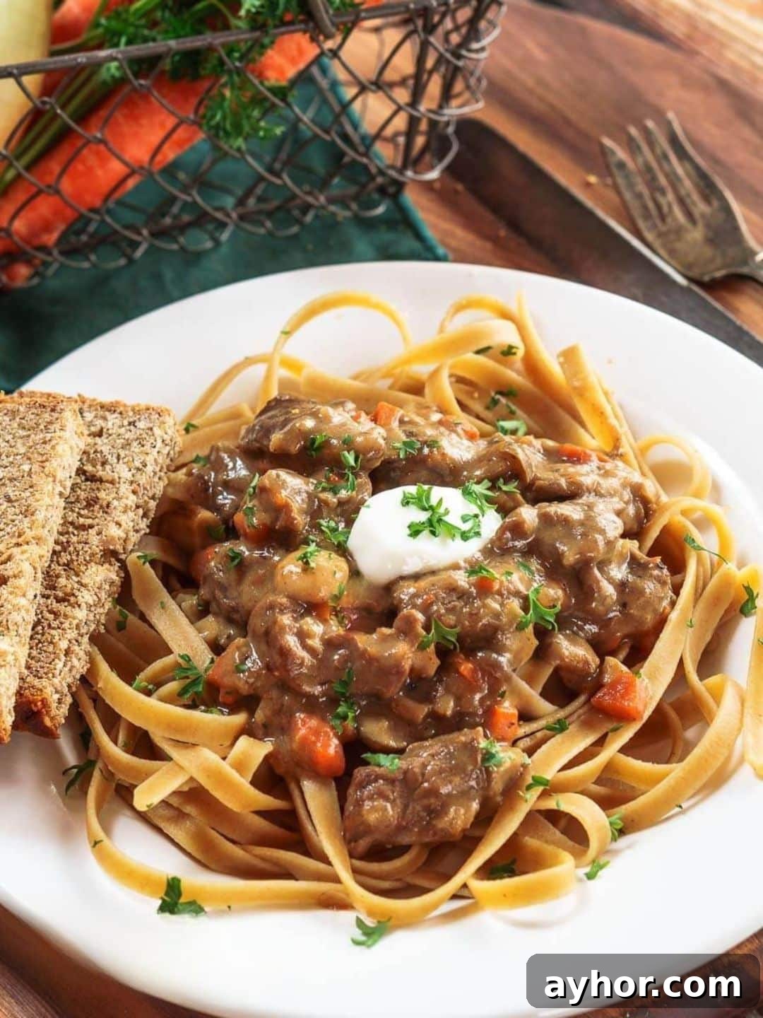 Top down view of a bowl of the best beef stroganoff recipe served over whole wheat pasta - Hostess At Heart