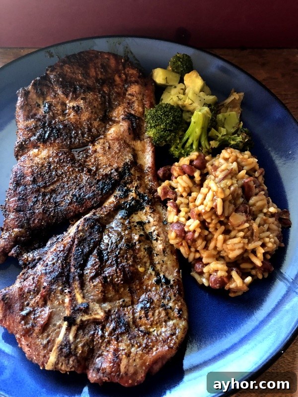Taco Seasoned Grilled Steaks served with broccoli and beans & rice on blue plate