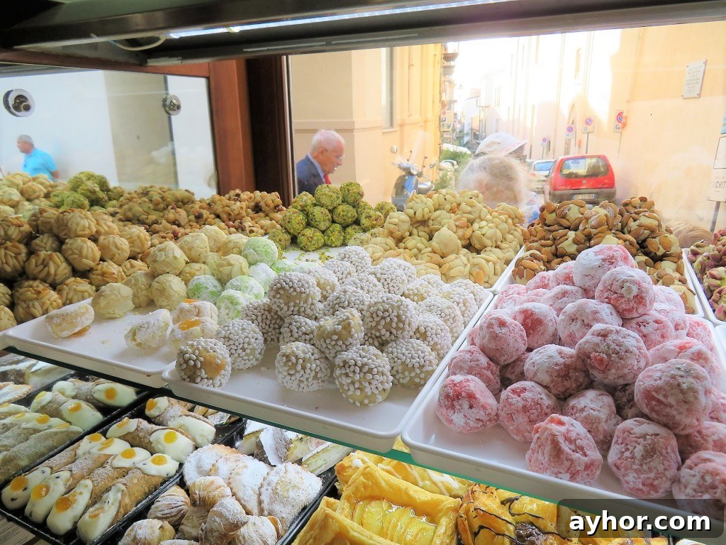 Savor Sicilian Almond Cookies While People Watching in Italy 7 bakery window full of Sicilian Almond Cookies