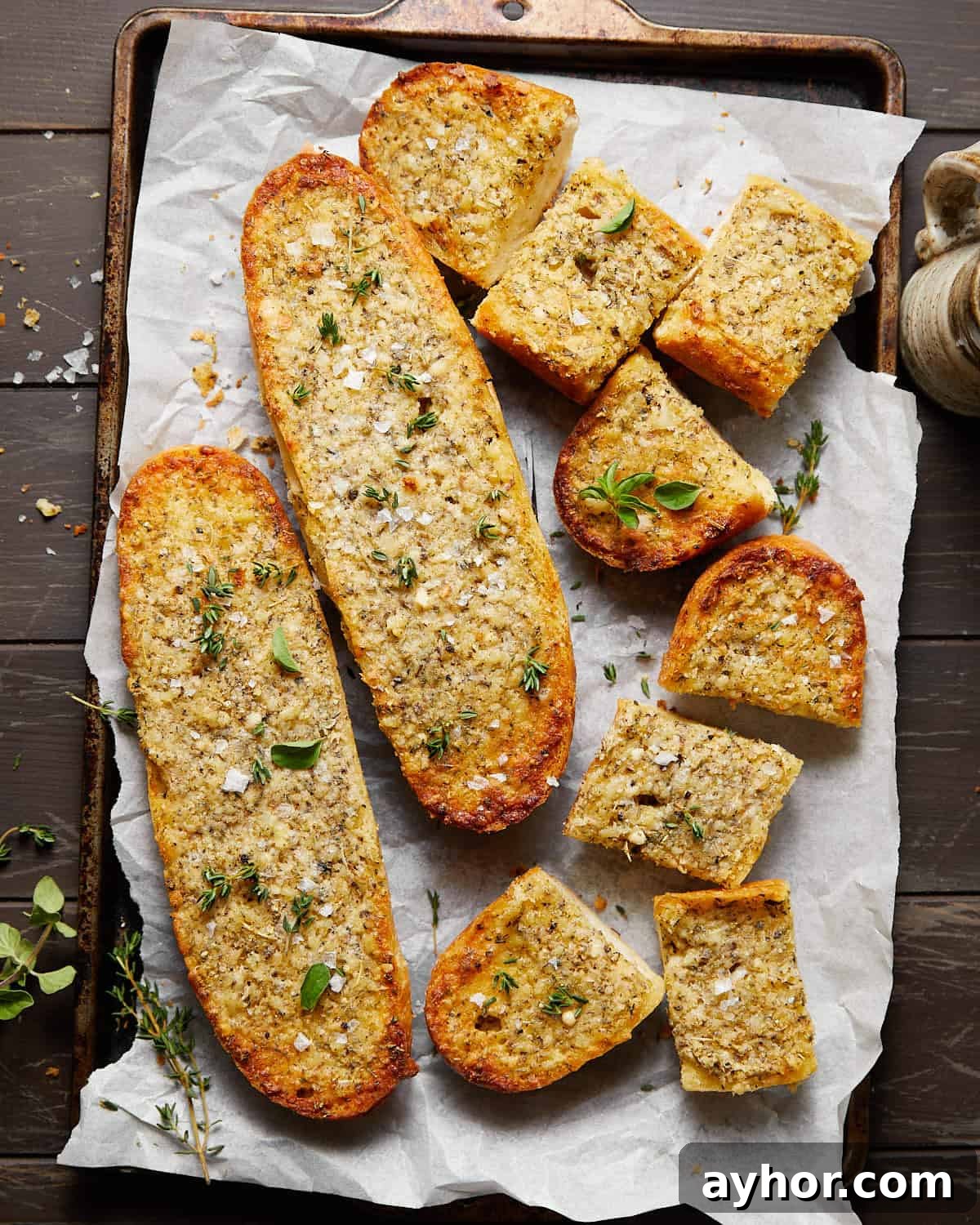 Image of garlic bread spread with garnish.
