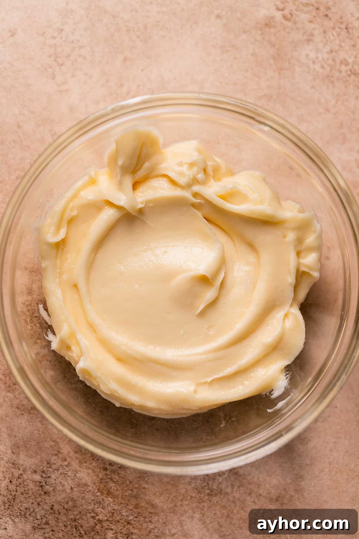 Cinnabon-Style Cinnamon Roll Cake Recipe 11 Cream cheese frosting in a bowl.