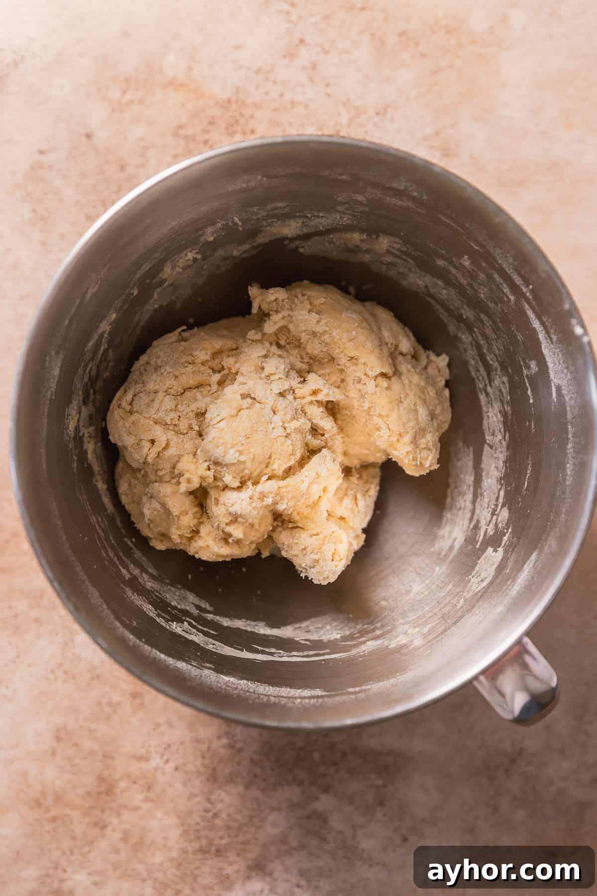 Cinnabon-Style Cinnamon Roll Cake Recipe 5 Rough dough in a mixing bowl before kneading in the butter.