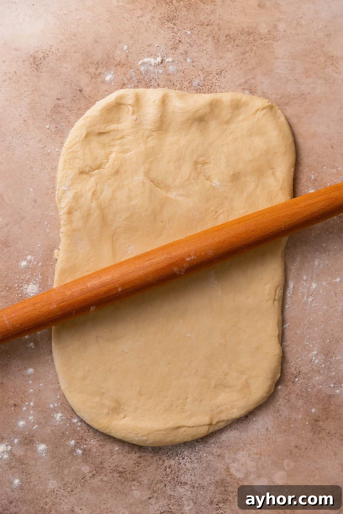 Cinnabon-Style Cinnamon Roll Cake Recipe 7 A rolling pin rolling out the dough.