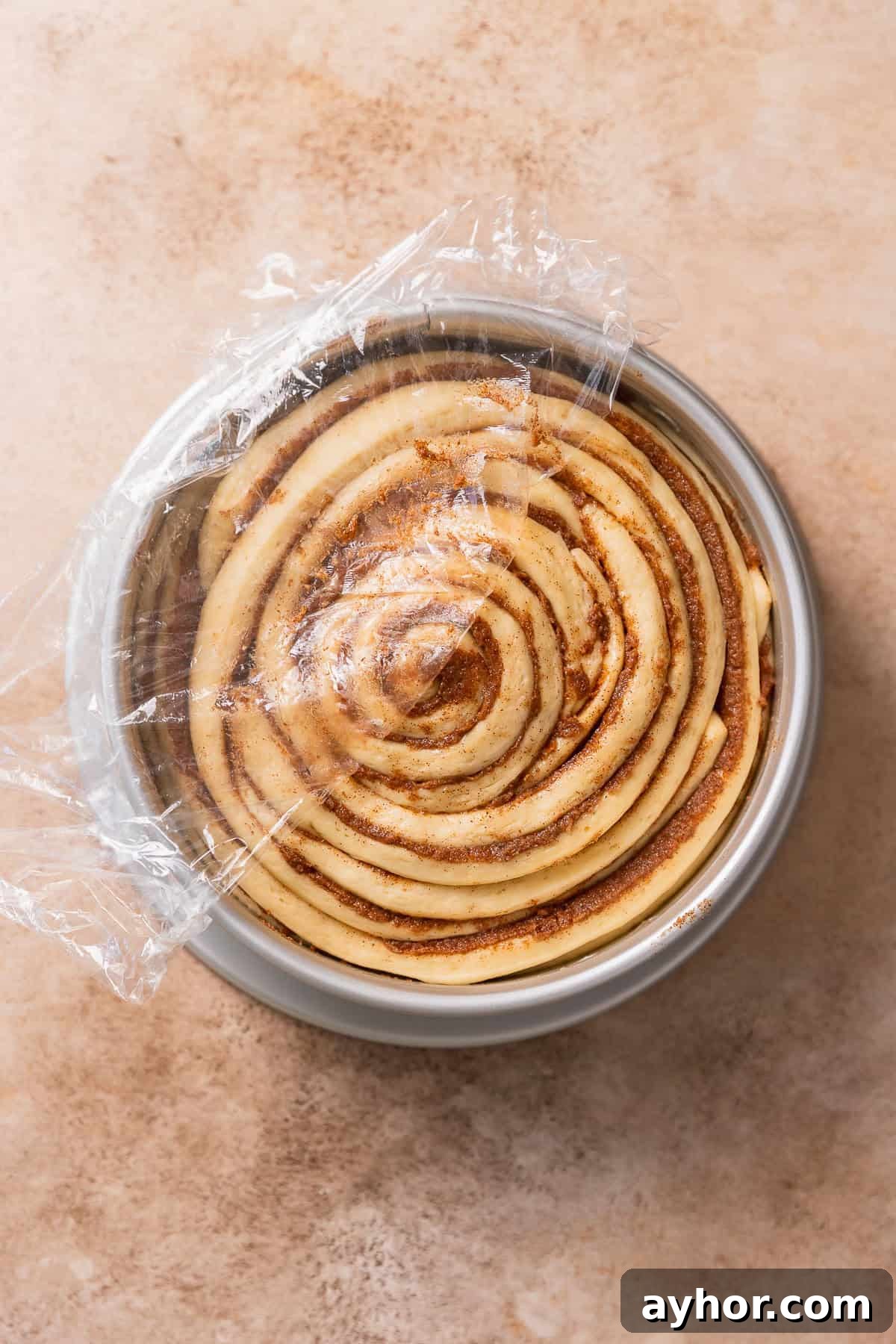 Cinnabon-Style Cinnamon Roll Cake Recipe 10 The cinnamon bun in a pan doubled in size right before baking.
