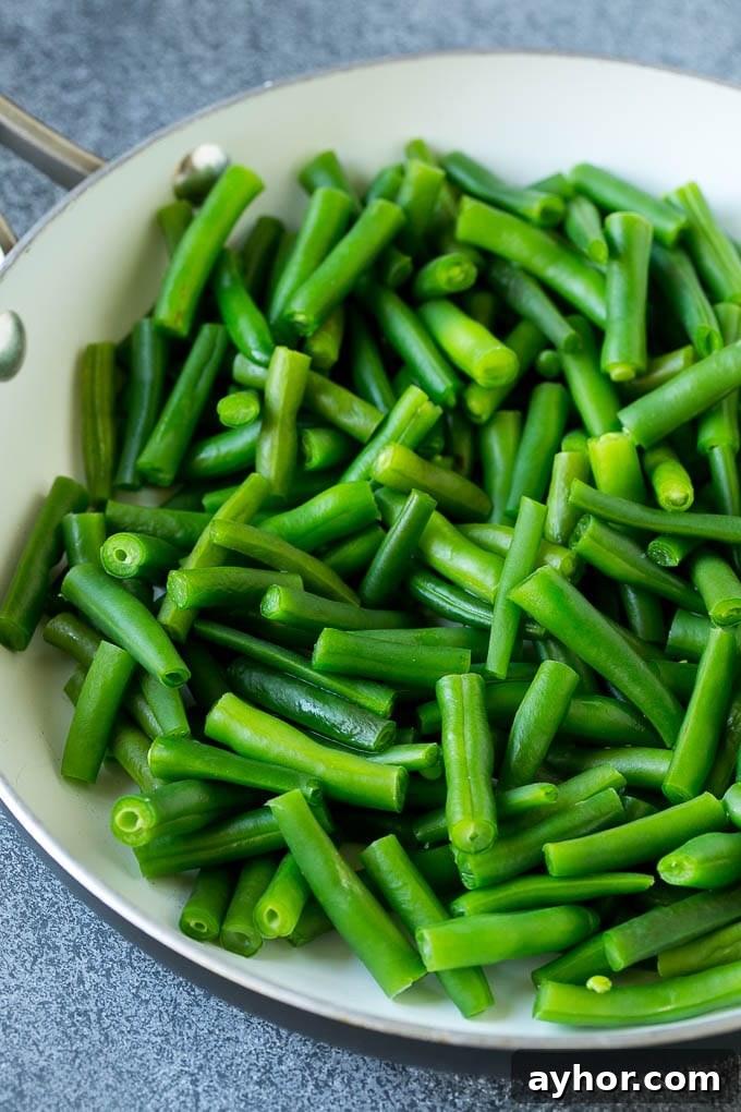 Cooked green beans in a pan.
