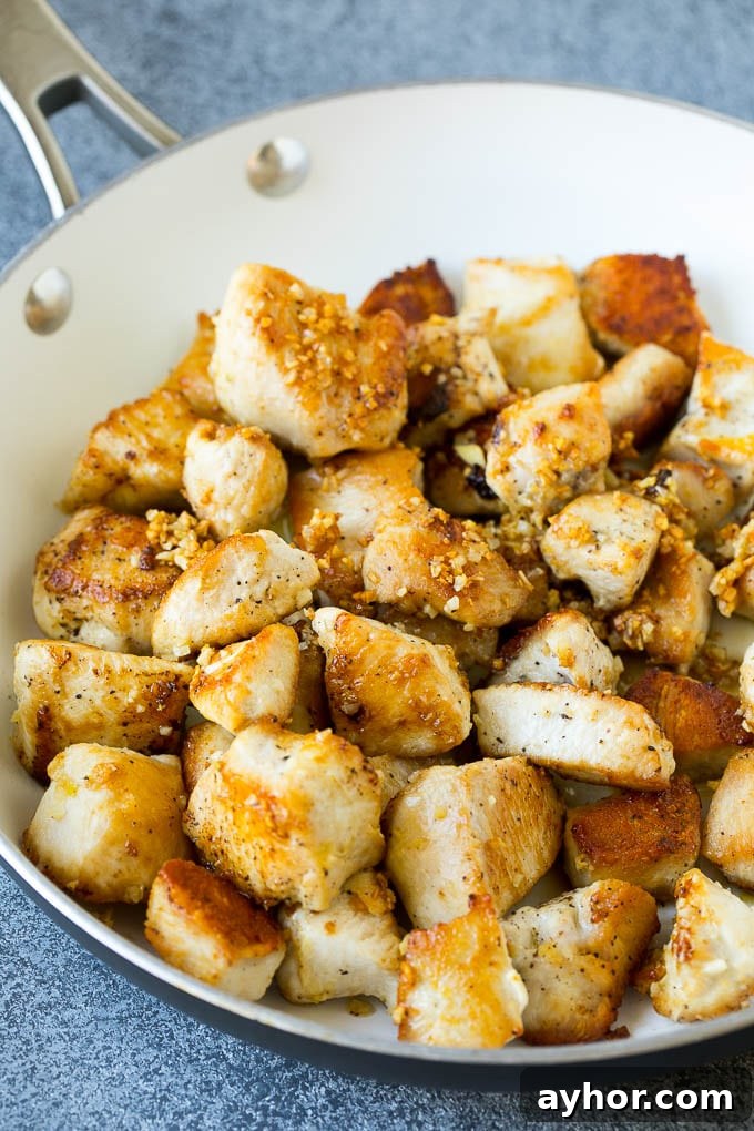 Seared chicken and garlic in a skillet.