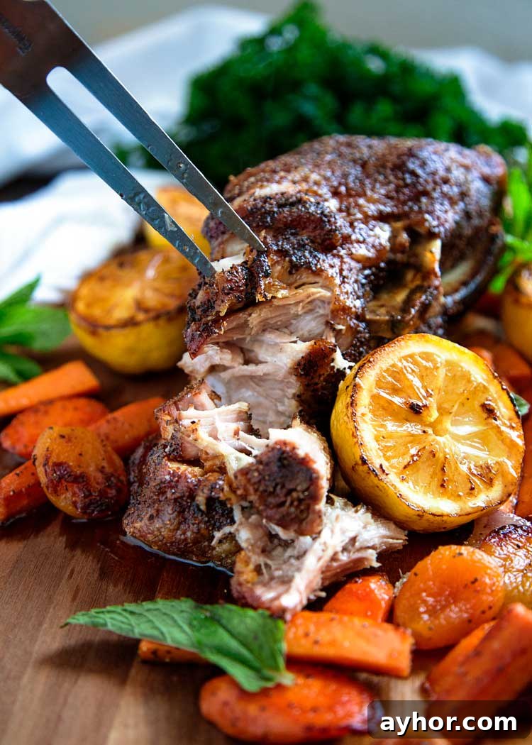 Slow-Roasted Pork Shoulder with Crispy Crackling 2 fork shredding roasted pork and roasted vegetables