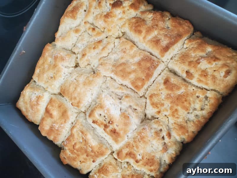 Flaky 7-Up Biscuits Recipe with How-To Video 3 square 7 up biscuits in baking dish right out of the oven