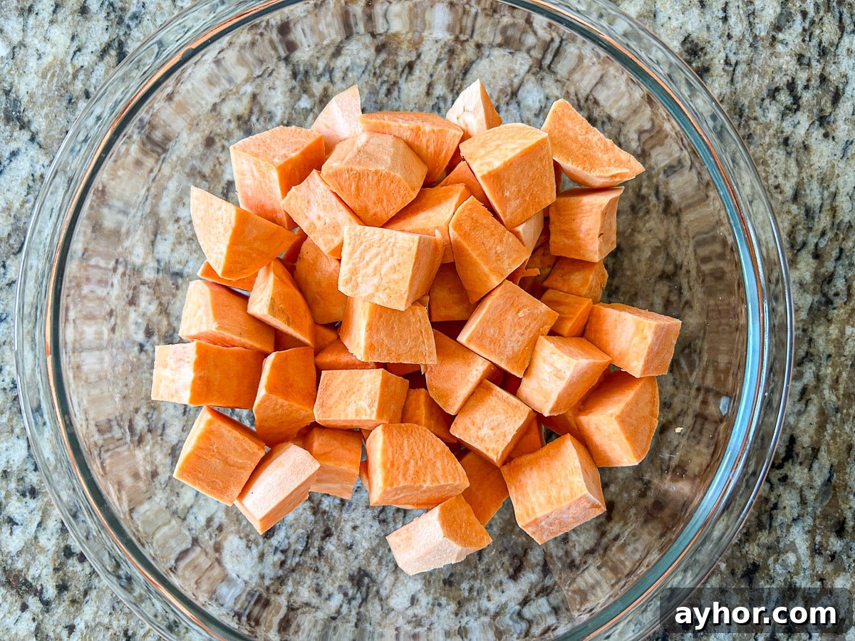 A glass bowl with big cubes of sweet potato