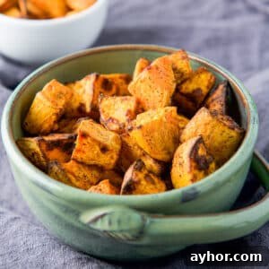 square photo of a green bowl filled with the potatoes