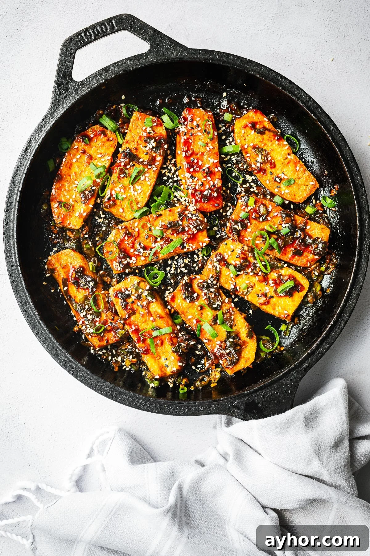Gochujang Braised Tofu: Spicy Korean Tofu Recipe 6 Korean braised tofu in a cast-iron skillet.