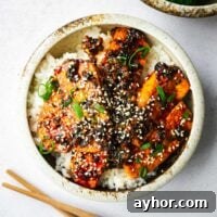 A rice bowl with extra-firm tofu pan-fried and braised in a spicy gochujang sauce.